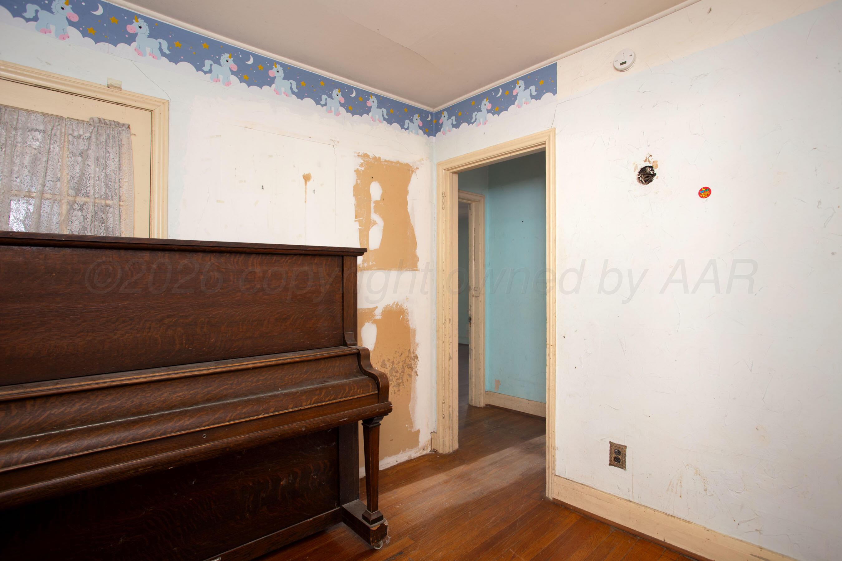 4223 Southwest 11th Avenue Amarillo, TX 79106 - Photo 15 of 26 a view of an empty room with wooden floor and a window
