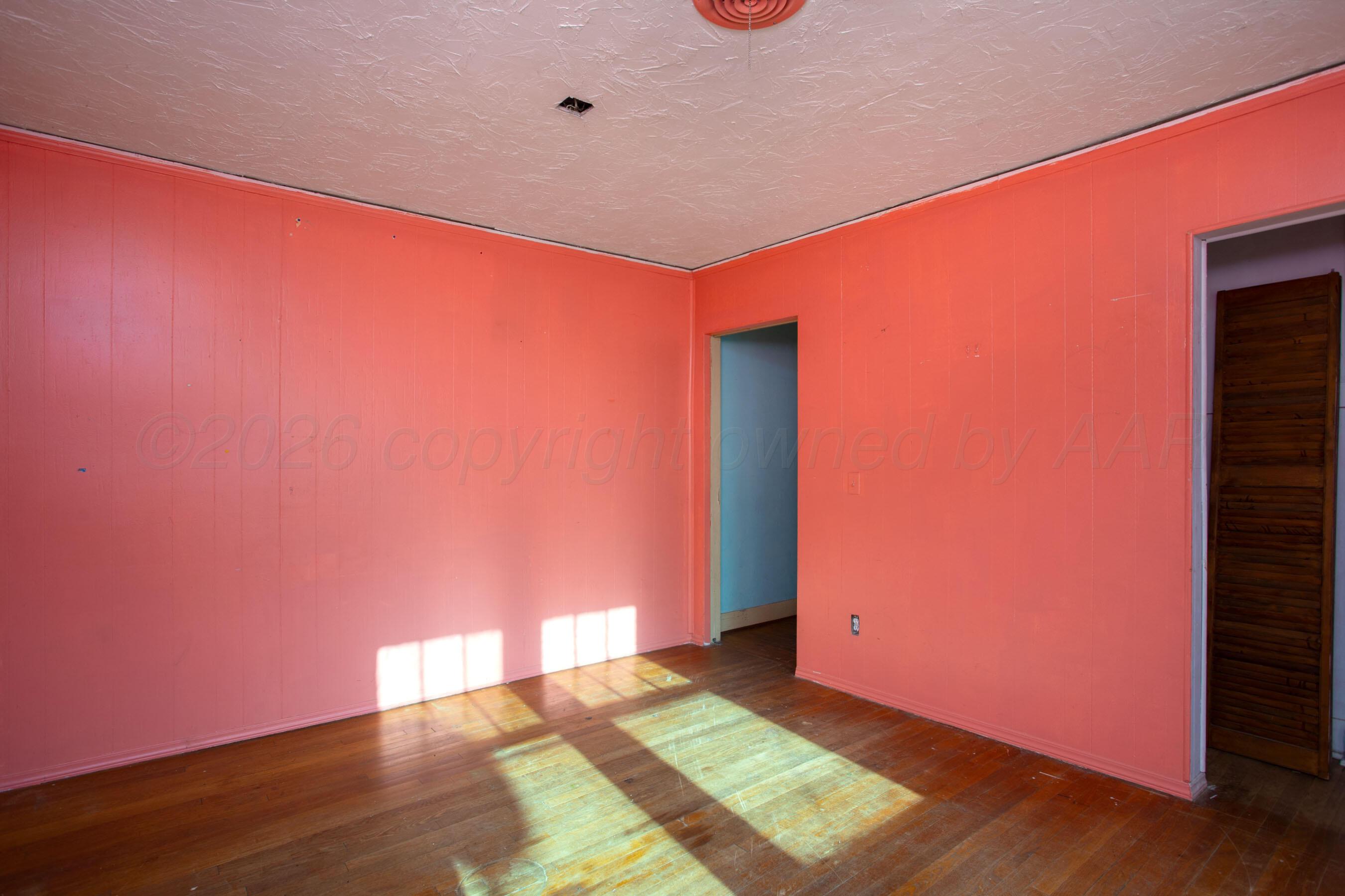 4223 Southwest 11th Avenue Amarillo, TX 79106 - Photo 18 of 26 a view of an empty room with wooden floor and a window