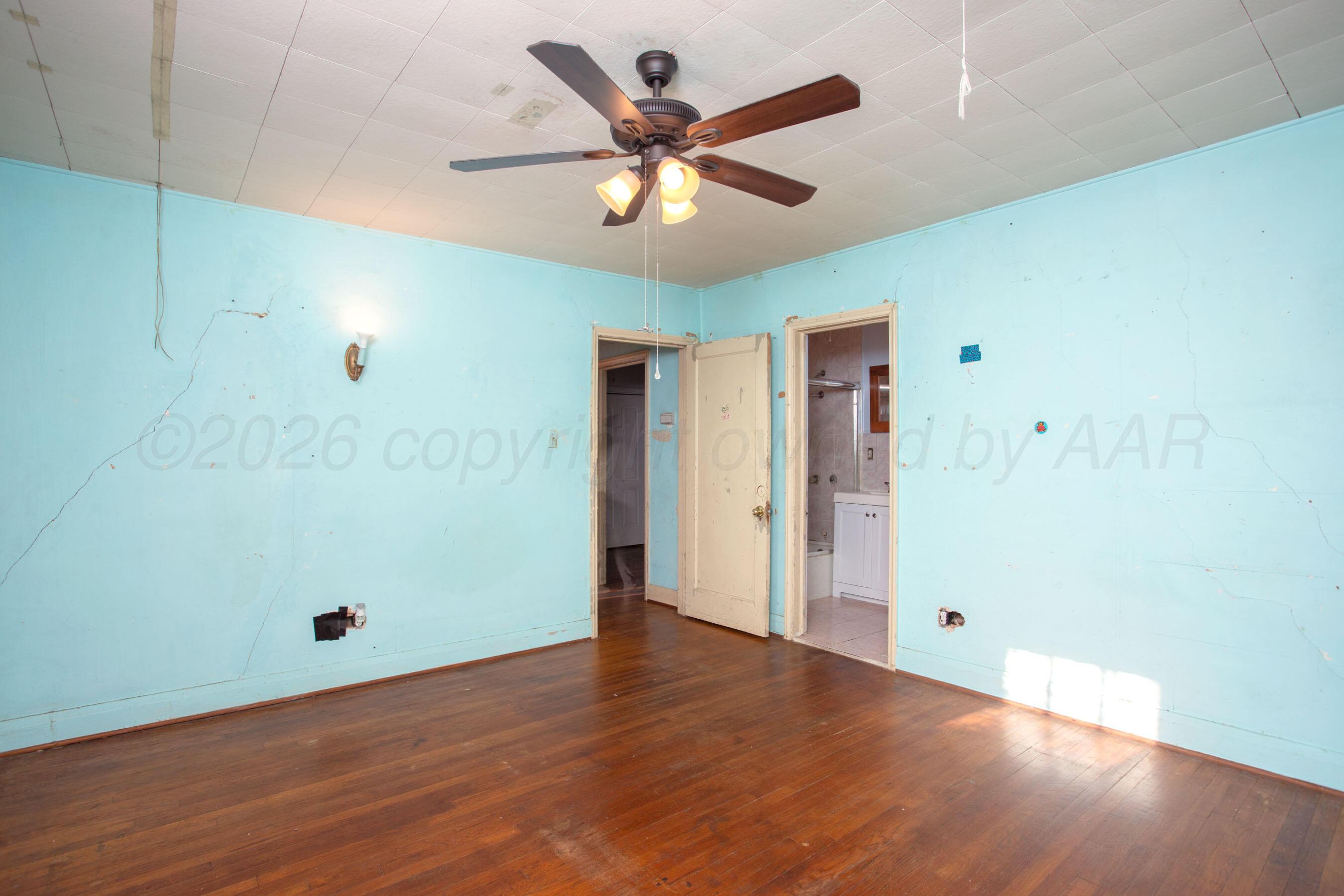 4223 Southwest 11th Avenue Amarillo, TX 79106 - Photo 21 of 26 a view of an empty room with wooden floor