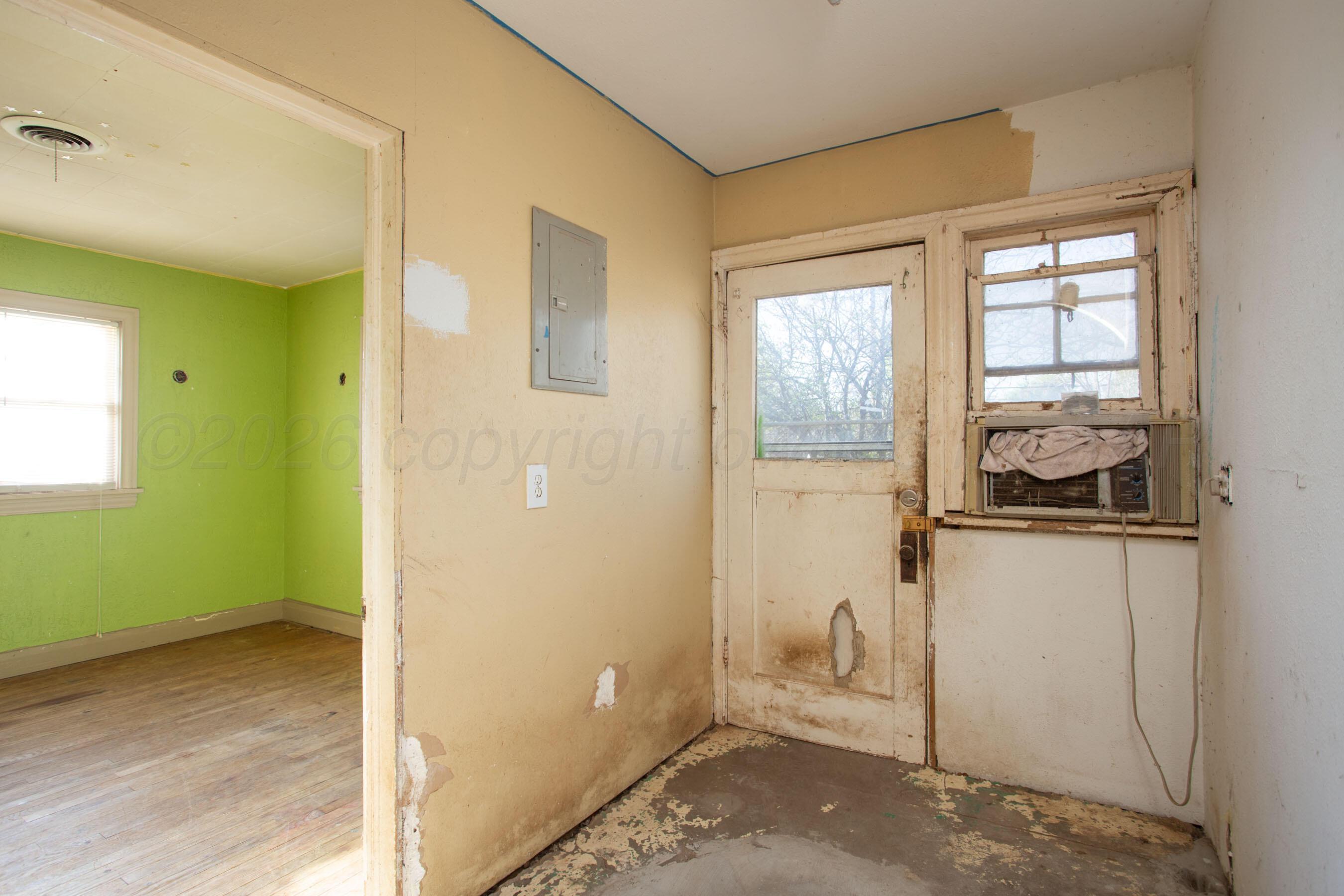 4223 Southwest 11th Avenue Amarillo, TX 79106 - Photo 26 of 26 a view of an empty room with wooden floor and a window