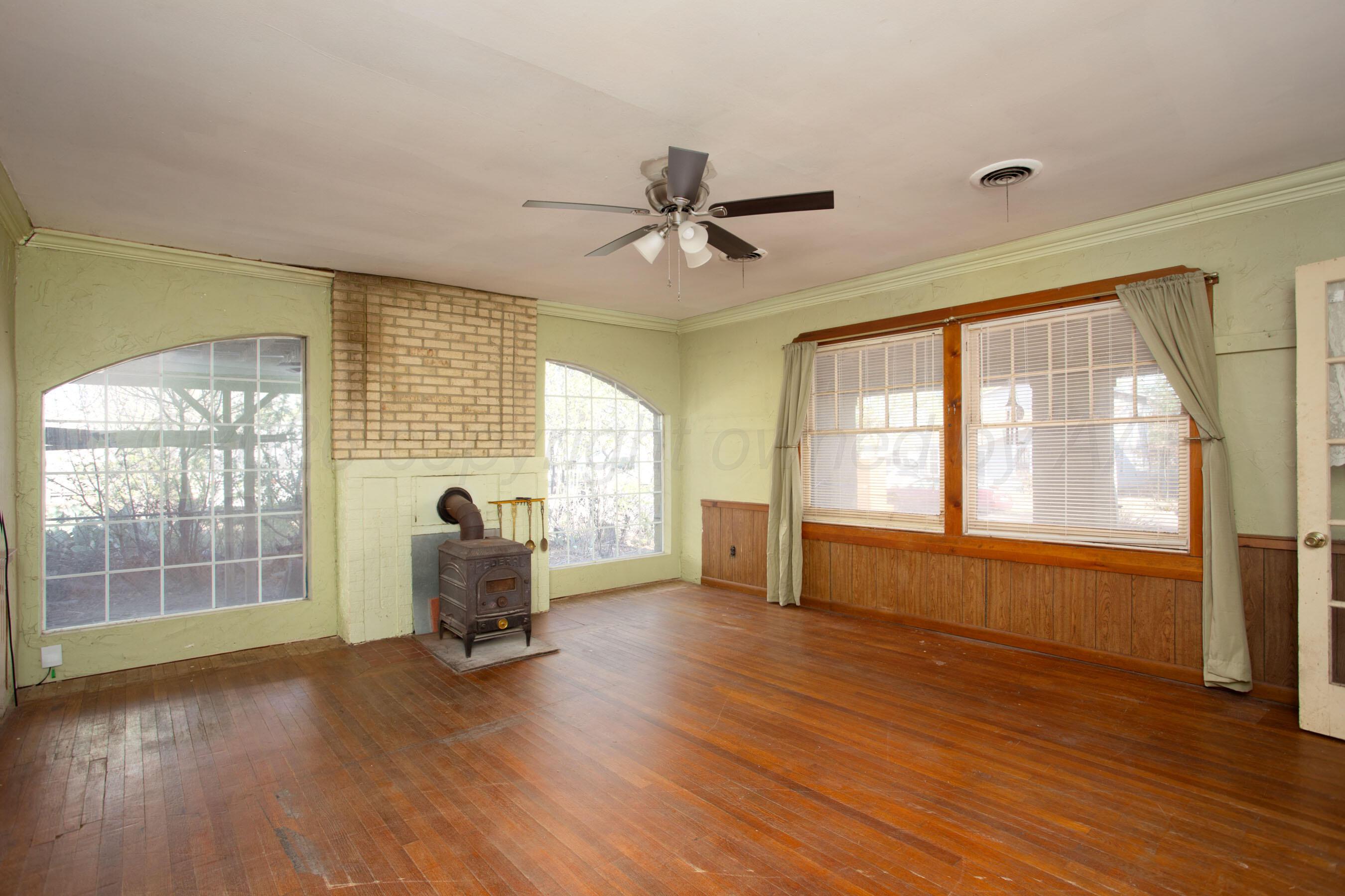 4223 Southwest 11th Avenue Amarillo, TX 79106 - Photo 8 of 26 an empty room with wooden floor and windows