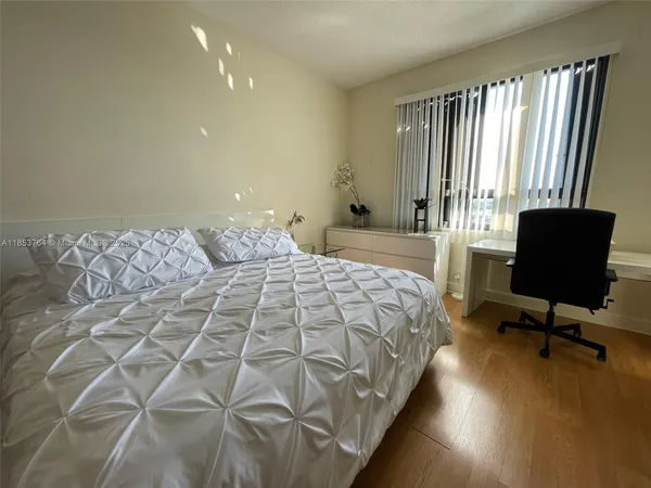 a bedroom with bed and a window