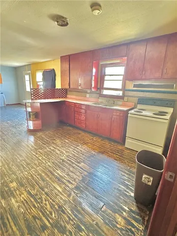 a kitchen with a sink wooden cabinets and counter top space
