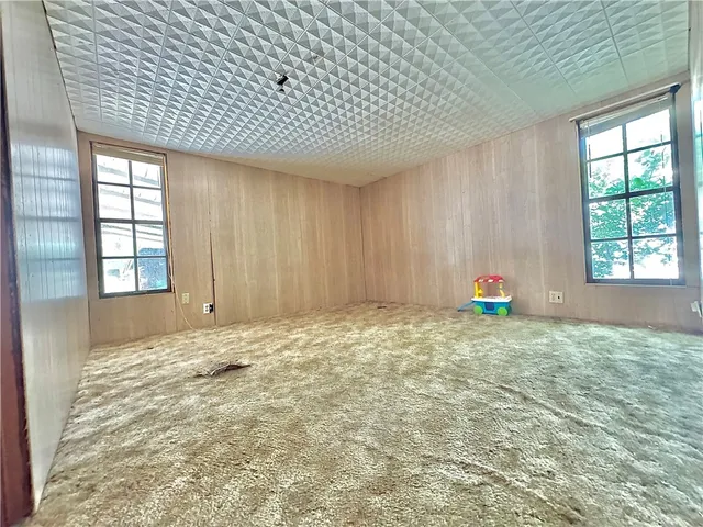 a view of empty room with window and fireplace