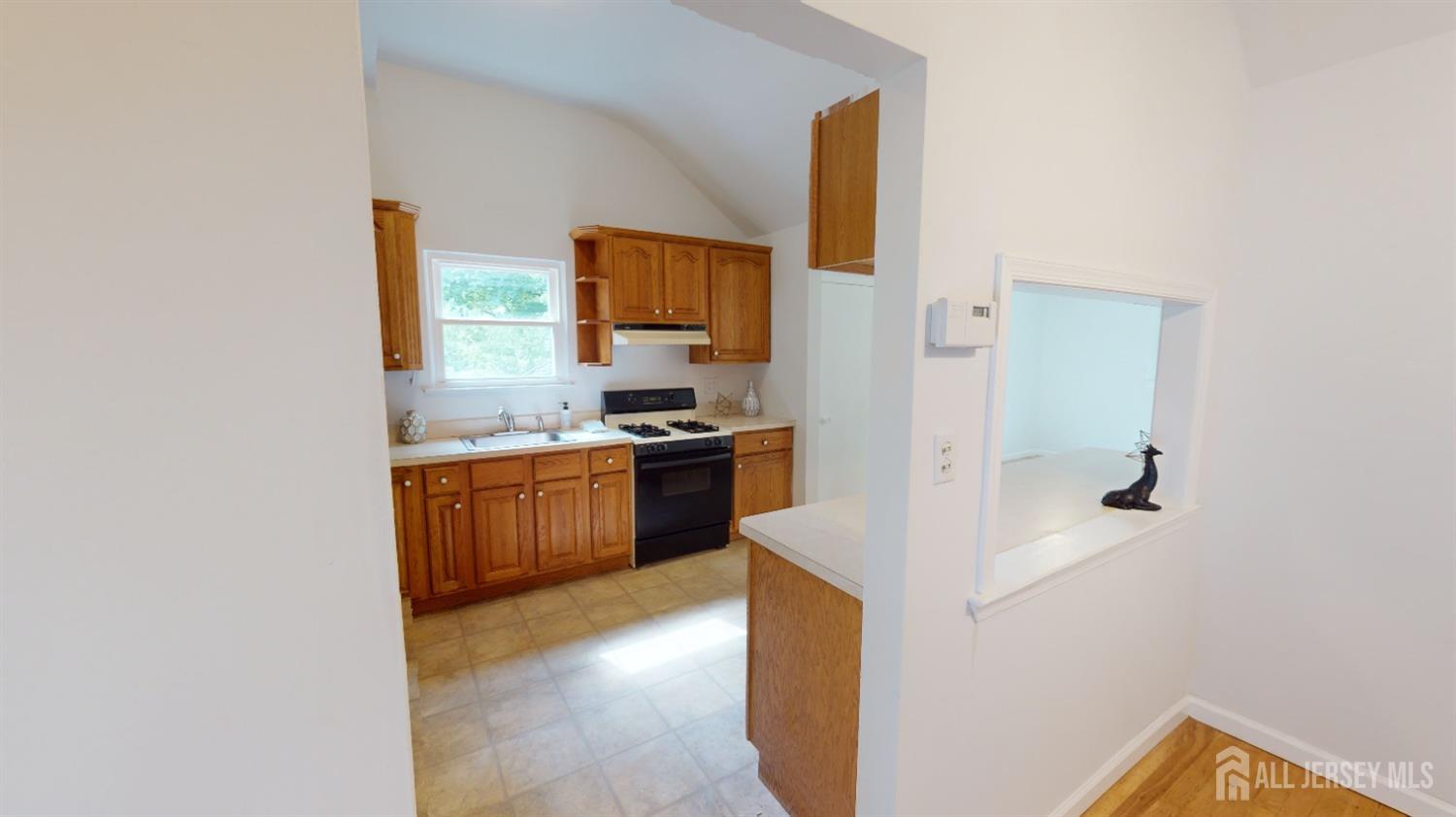 3 Donald Road East Brunswick, NJ 08816 - Photo 14 of 62 a kitchen with a refrigerator and a stove