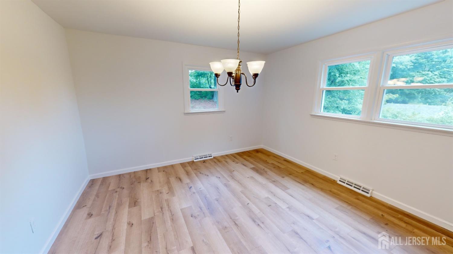 3 Donald Road East Brunswick, NJ 08816 - Photo 20 of 62 a view of empty room with wooden floor and fan