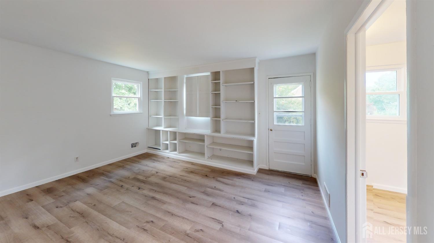 3 Donald Road East Brunswick, NJ 08816 - Photo 46 of 62 an empty room with wooden floor empty wooden shelves and windows