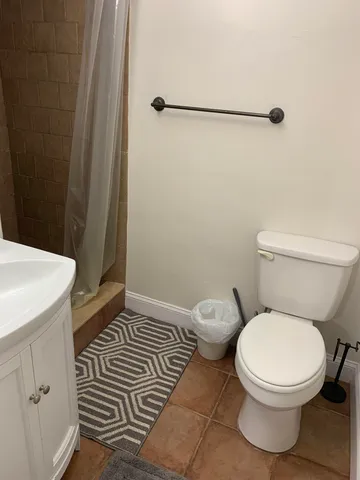a white toilet sitting next to a bathroom sink
