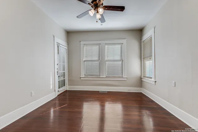 wooden floor in an empty room with a window