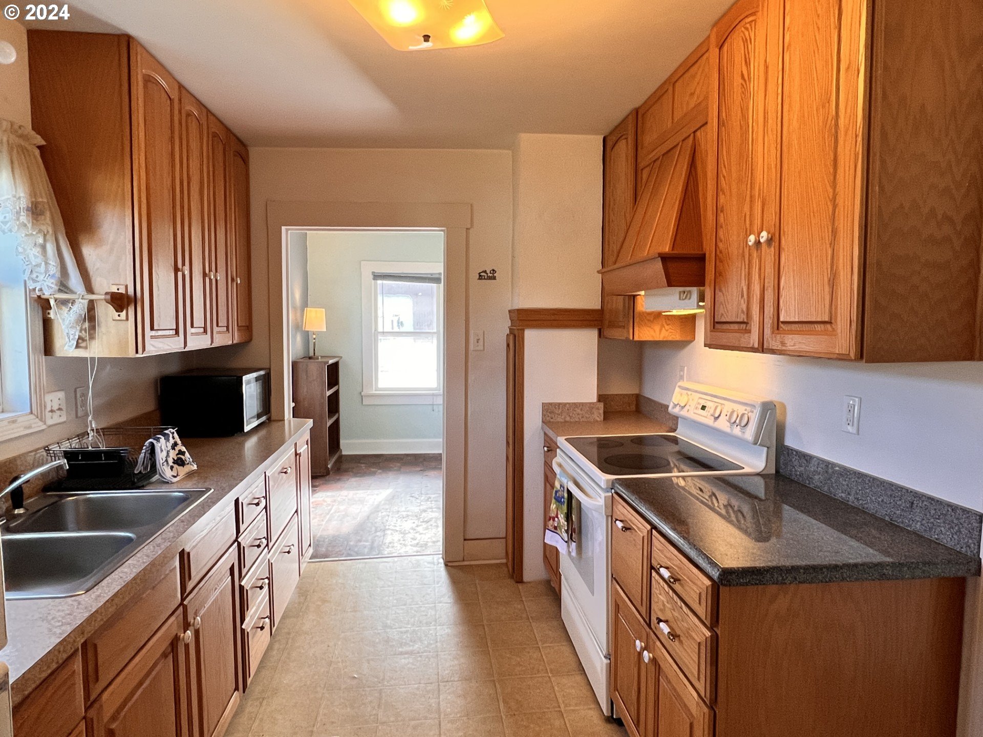 2149 Dogwood Avenue Reedsport, OR 97467 - Photo 11 of 41 a kitchen with a sink stove top oven and cabinets
