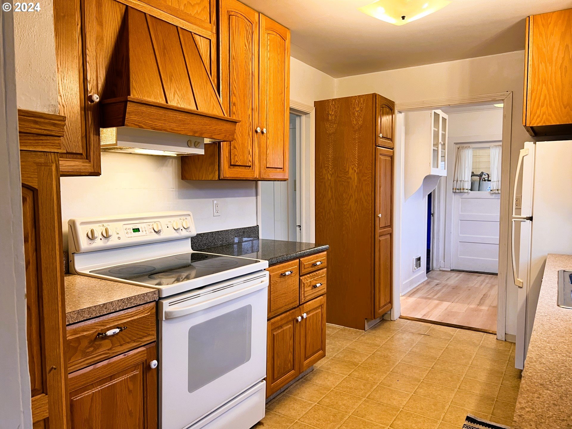 2149 Dogwood Avenue Reedsport, OR 97467 - Photo 12 of 41 a kitchen with stainless steel appliances granite countertop a refrigerator and a stove top oven