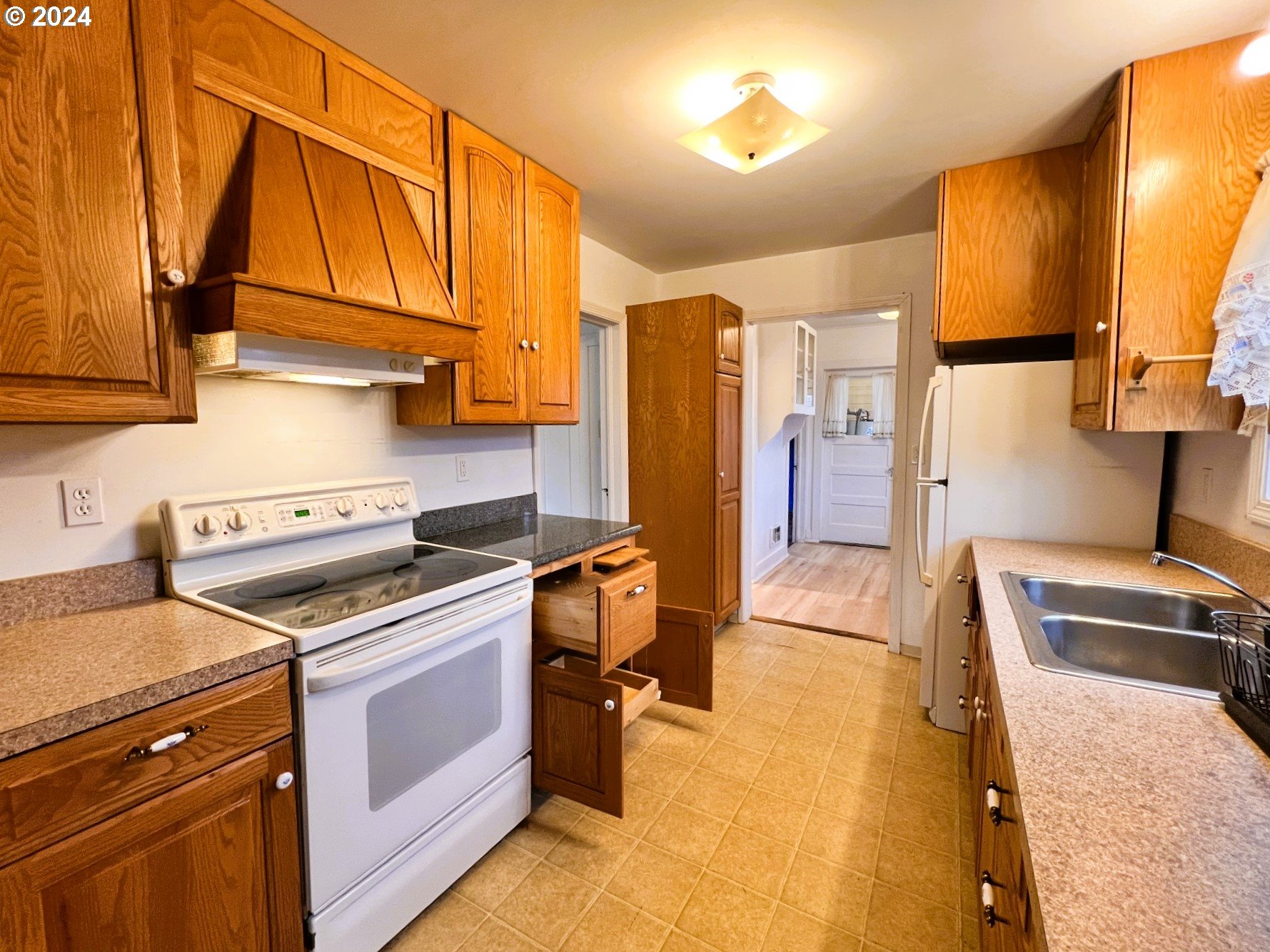 2149 Dogwood Avenue Reedsport, OR 97467 - Photo 13 of 41 a kitchen with stainless steel appliances granite countertop a stove a sink and a refrigerator