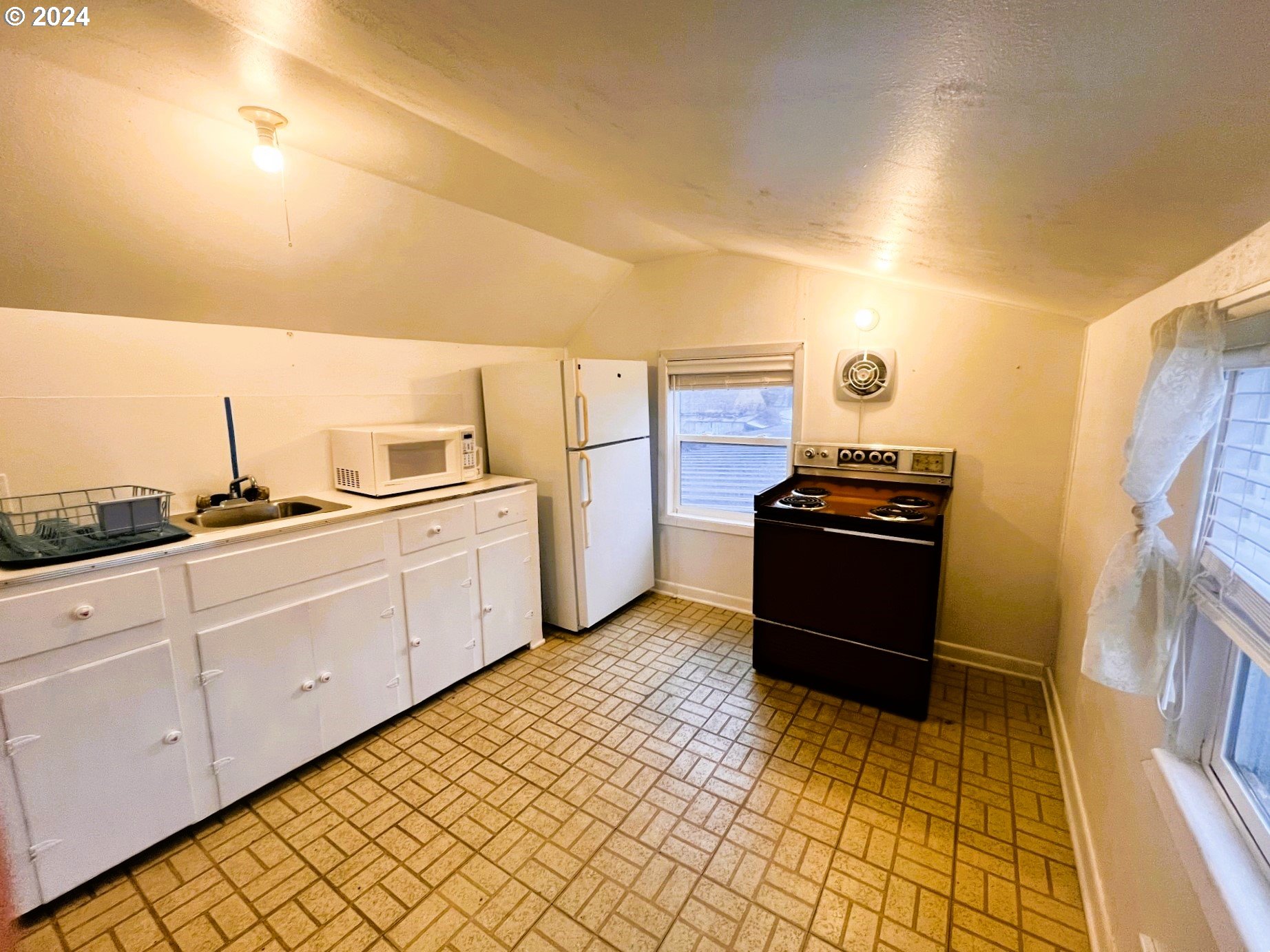 2149 Dogwood Avenue Reedsport, OR 97467 - Photo 30 of 41 a kitchen with a stove and a refrigerator
