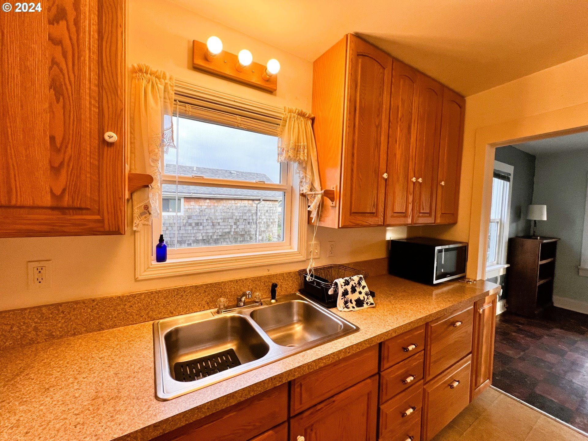 2149 Dogwood Avenue Reedsport, OR 97467 - Photo 10 of 41 a kitchen with a sink cabinets and black stainless steel appliances