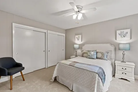 a bedroom with a bed and a chair