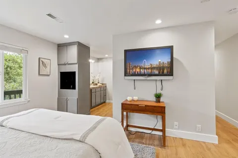 a bedroom with a bed and a chair