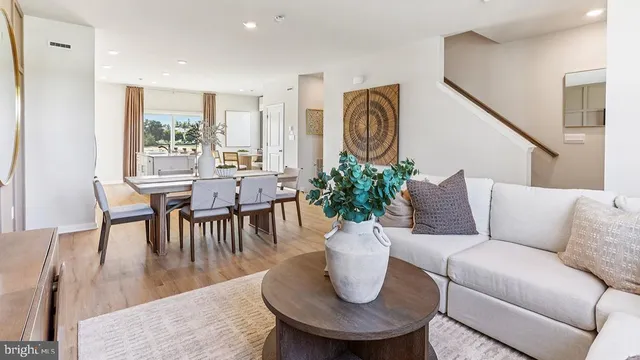 a dining room with furniture and wooden floor