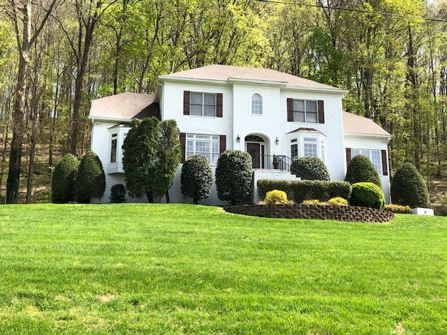 758 High Point Ridge Road Franklin, TN 37069 - Photo 3 of 28 a front view of a house with a garden and yard
