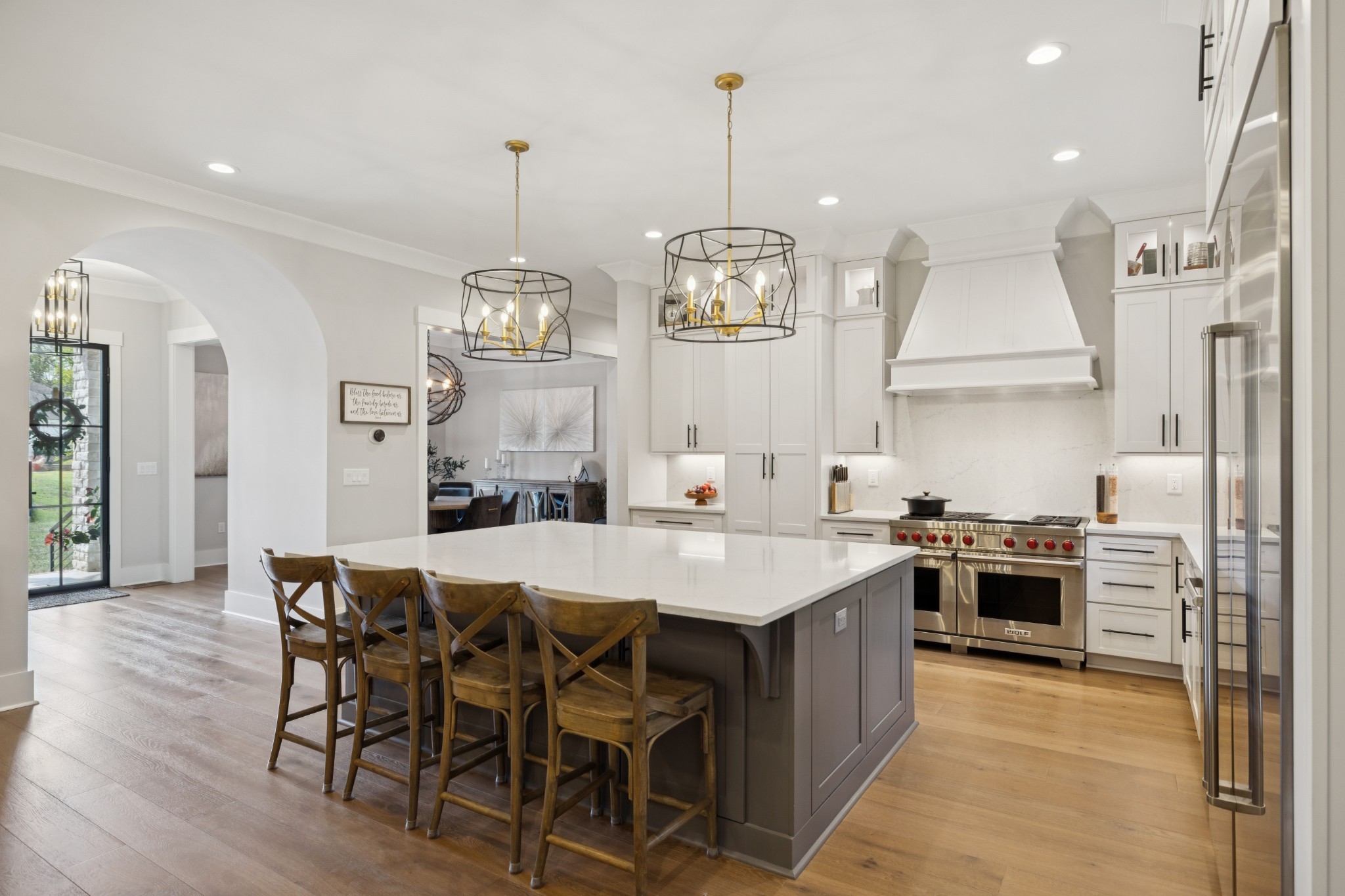 5012 Toll Rd Court Thompson's Station, TN 37179 - Photo 15 of 95 a kitchen with stainless steel appliances granite countertop a stove a sink a refrigerator a stove a kitchen island with a dining table and chairs