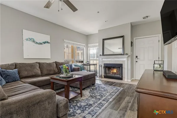 a living room with furniture and a fireplace