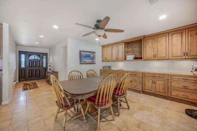 a living room with lots of furniture and a view of kitchen