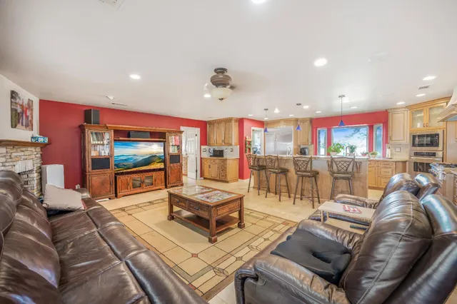 a large kitchen with stainless steel appliances granite countertop a sink and cabinets