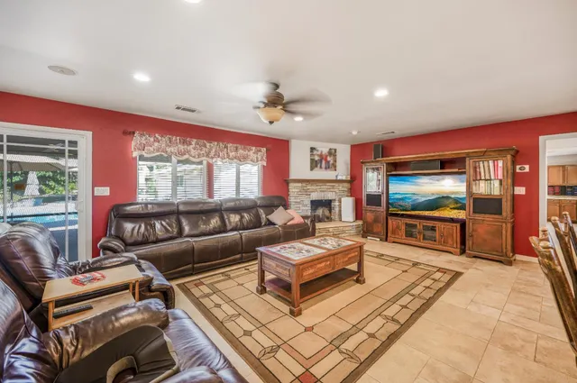a large kitchen with granite countertop a sink and a refrigerator