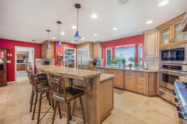 a kitchen with stainless steel appliances granite countertop a sink and cabinets