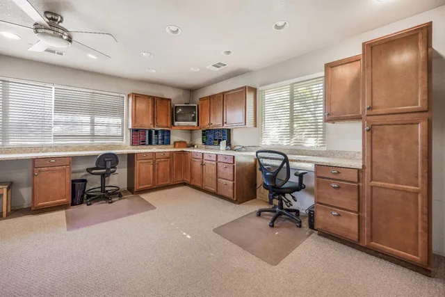 a bathroom with a granite countertop sink a mirror and a vanity