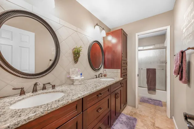 a view of a patio with a table and chairs under an umbrella
