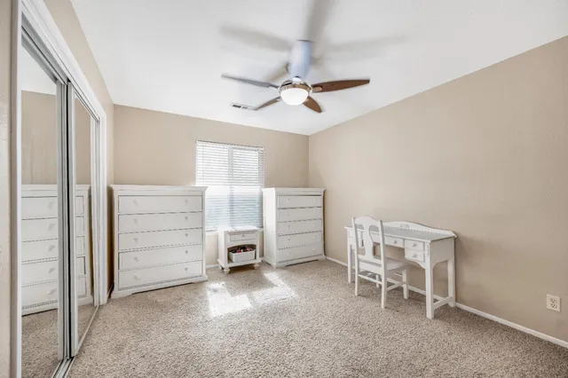 a patio with a table and chairs under an umbrella
