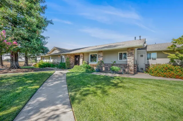 a front view of a house with a garden