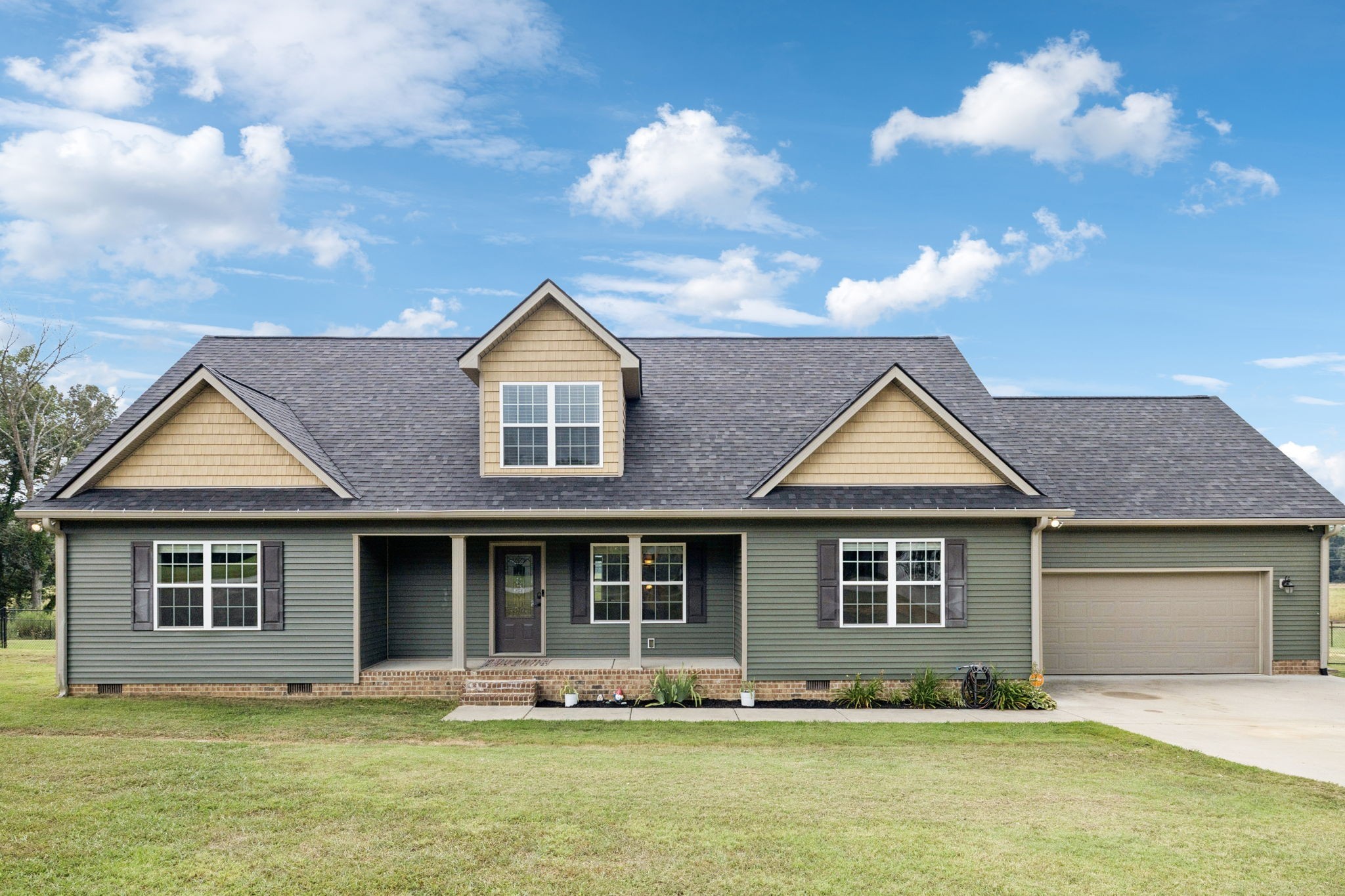 a front view of a house with a yard