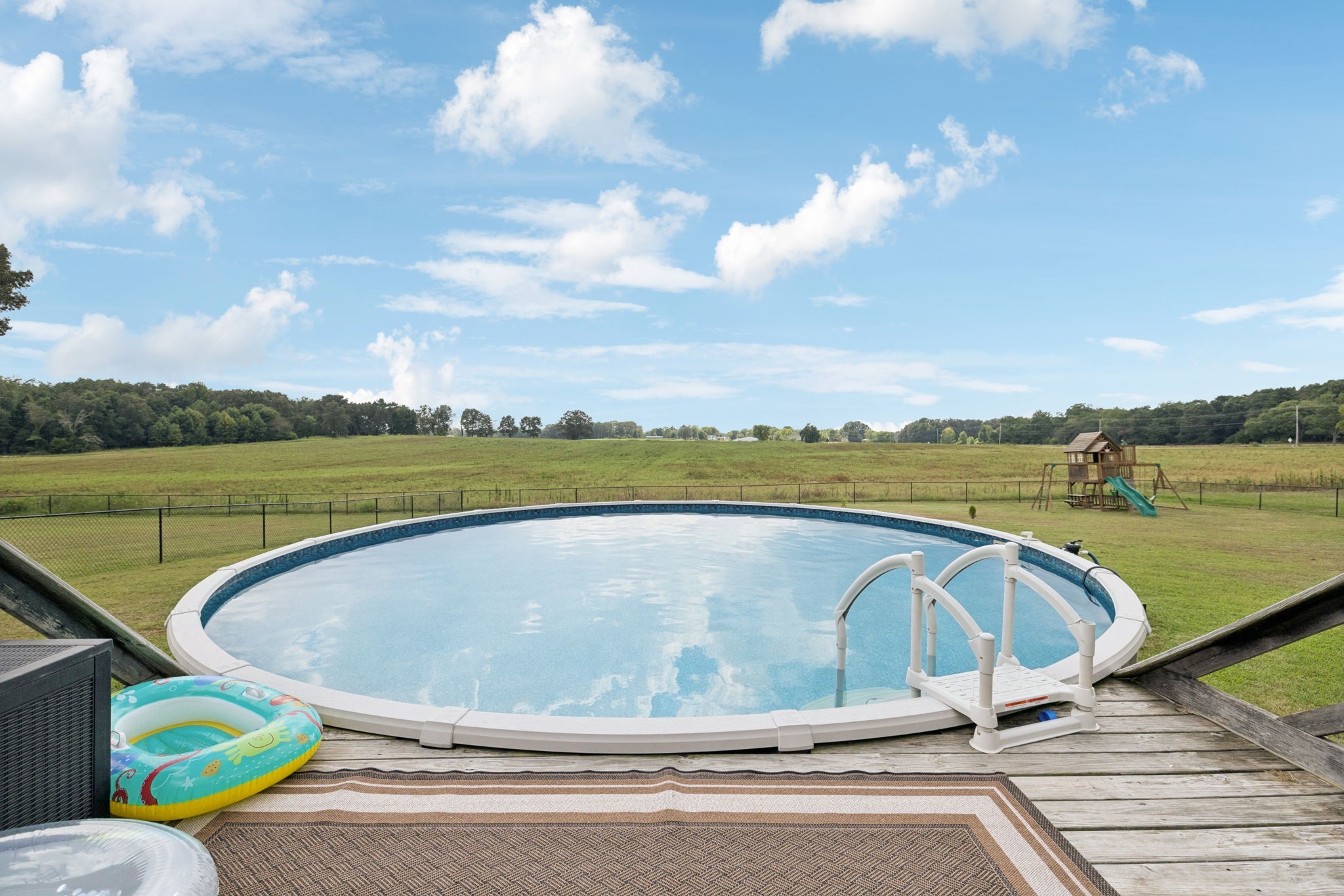 68 Taylor Road Manchester, TN 37355 - Photo 24 of 33 a view of a swimming pool with a lake view and wooden floor