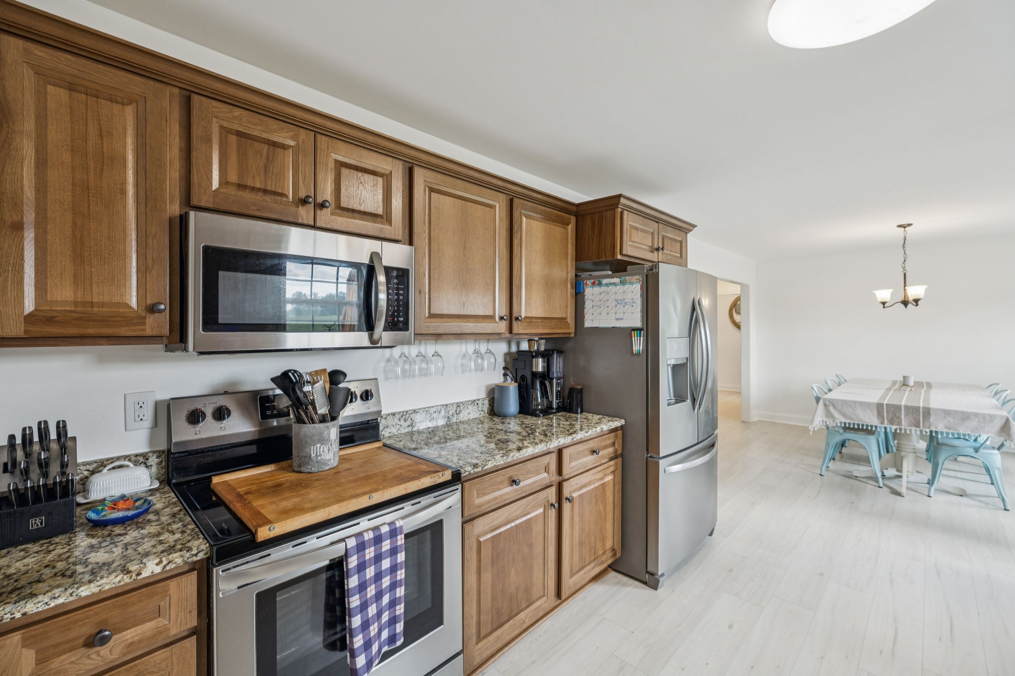 68 Taylor Road Manchester, TN 37355 - Photo 7 of 33 a kitchen with stainless steel appliances granite countertop a stove top oven a sink dishwasher and a refrigerator with wooden cabinets