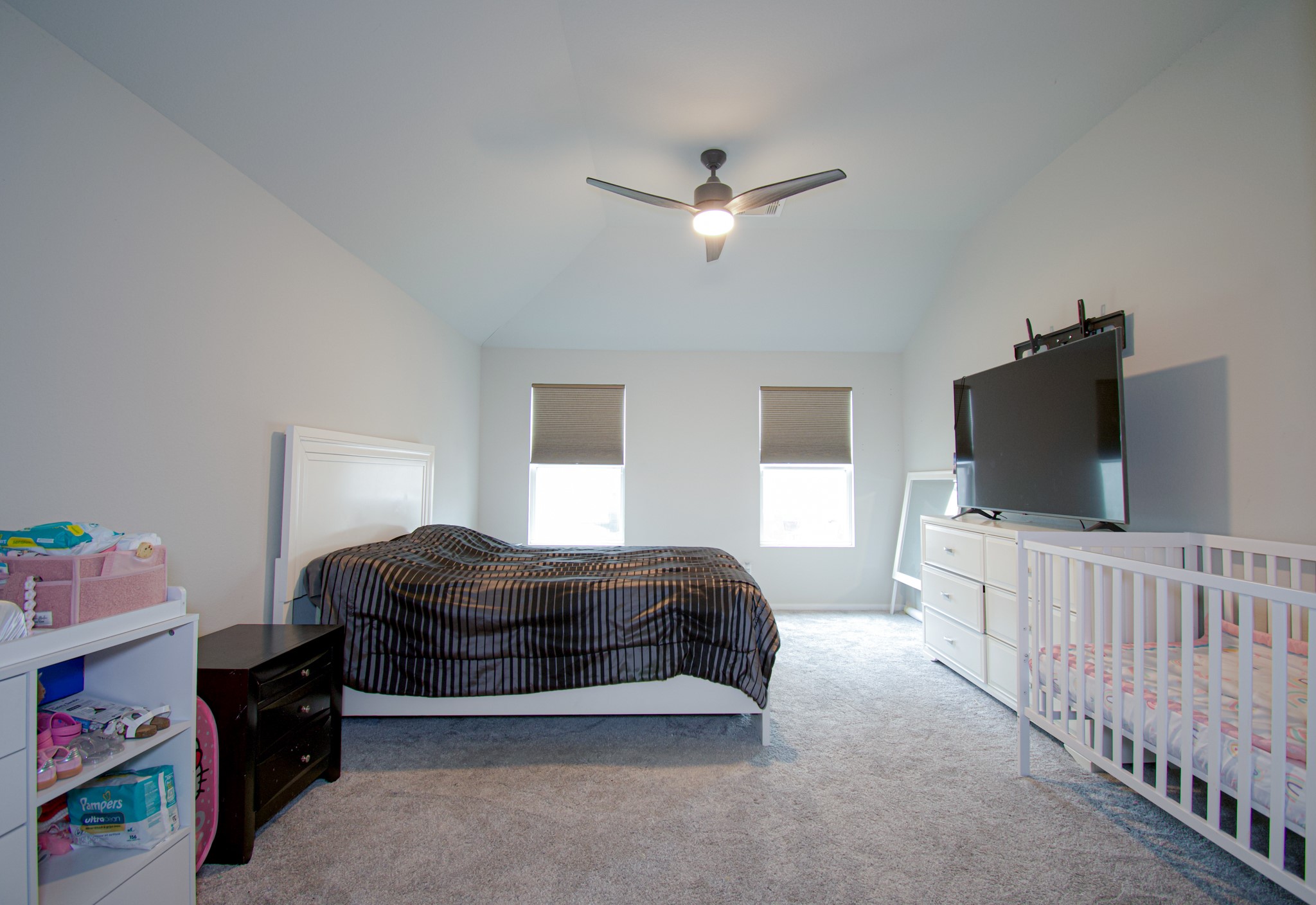 2642 Ridgeback Drive Rosenberg, TX 77471 - Photo 8 of 13 a bedroom with a bed and a flat screen tv