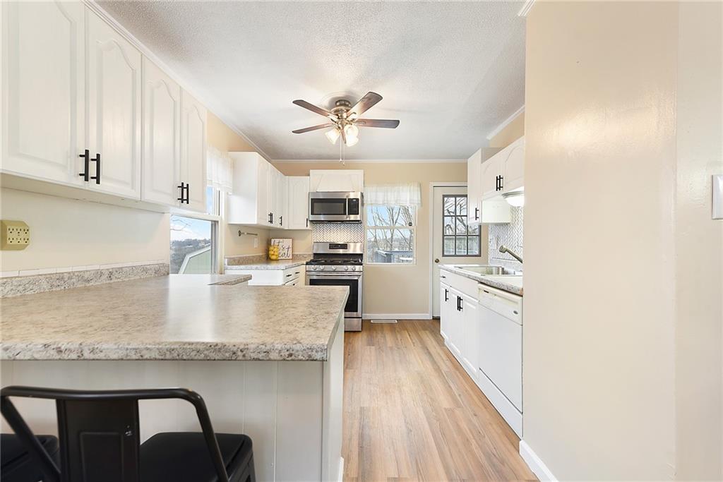 127 Sunset Drive Washington, PA 15301 - Photo 11 of 33 a large kitchen with granite countertop lots of counter top space and stainless steel appliances