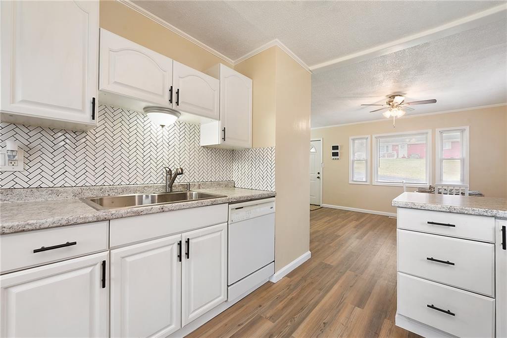 127 Sunset Drive Washington, PA 15301 - Photo 14 of 33 a kitchen with granite countertop white cabinets and white appliances