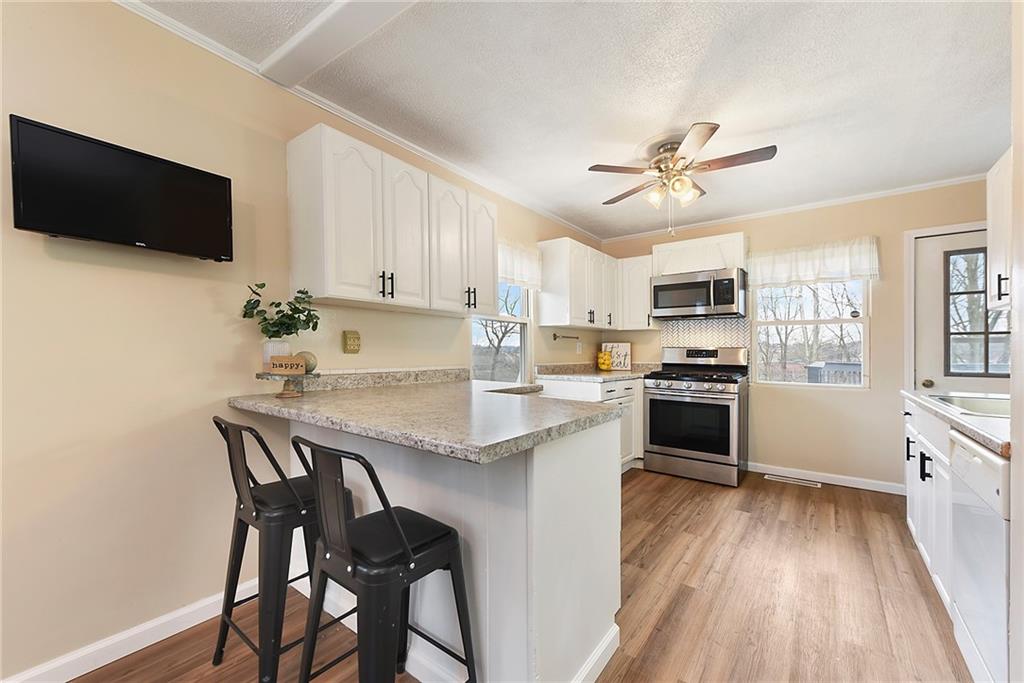 127 Sunset Drive Washington, PA 15301 - Photo 9 of 33 a kitchen with a table chairs microwave and cabinets