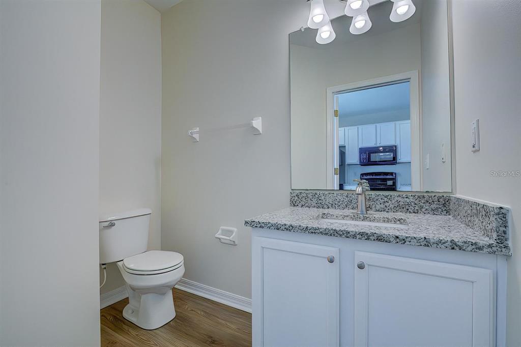15706 Stable Run Drive Spring Hill, FL 34610 - Photo 14 of 40 a bathroom with a granite countertop toilet sink and mirror