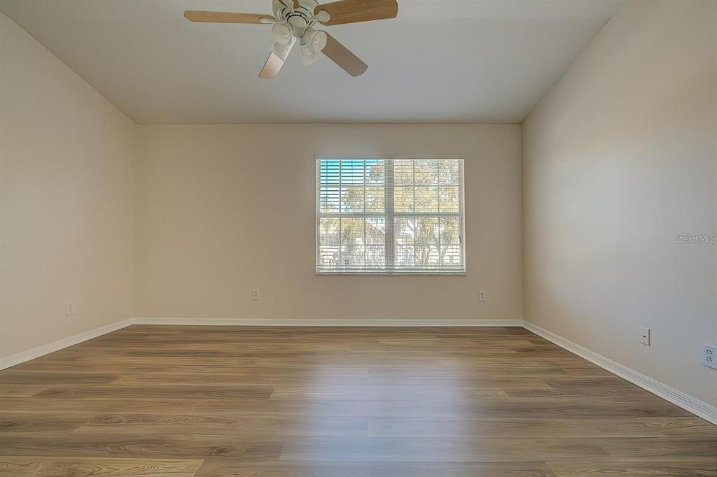 15706 Stable Run Drive Spring Hill, FL 34610 - Photo 20 of 40 wooden floor in an empty room with a window
