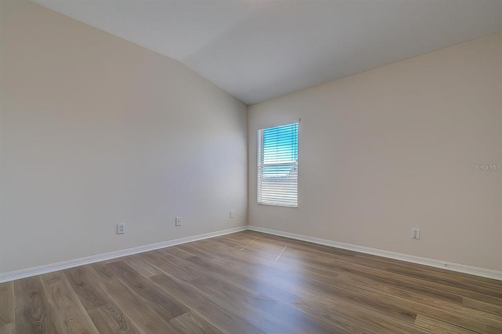 15706 Stable Run Drive Spring Hill, FL 34610 - Photo 23 of 40 a view of an empty room with wooden floor and a window