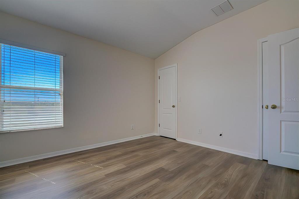 15706 Stable Run Drive Spring Hill, FL 34610 - Photo 24 of 40 a view of an empty room with wooden floor and a window