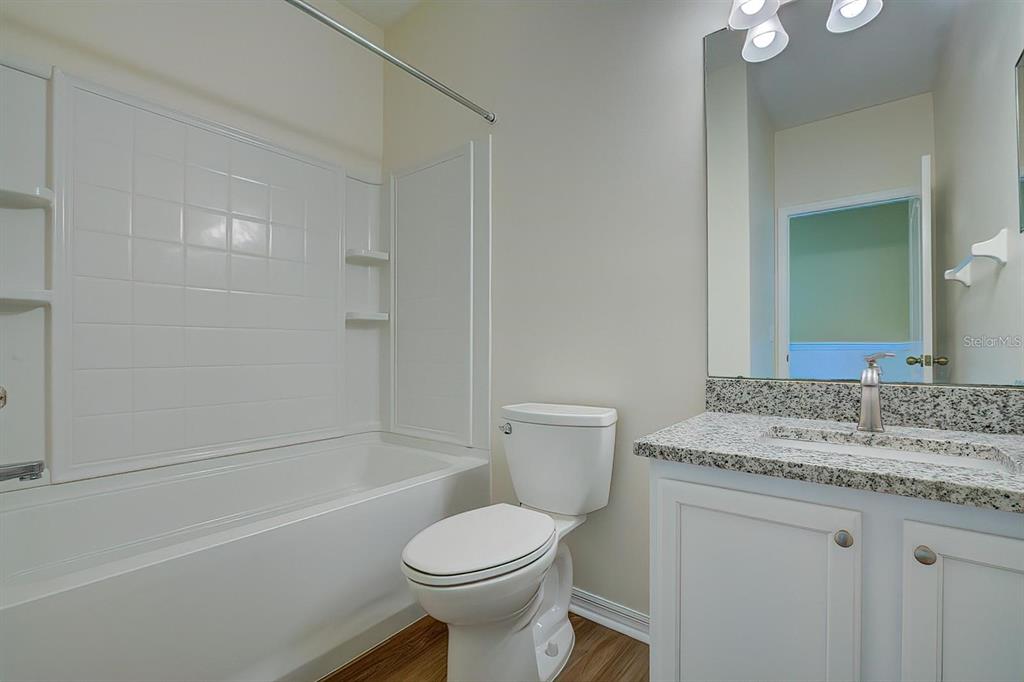 15706 Stable Run Drive Spring Hill, FL 34610 - Photo 26 of 40 a bathroom with a sink toilet vanity and shower