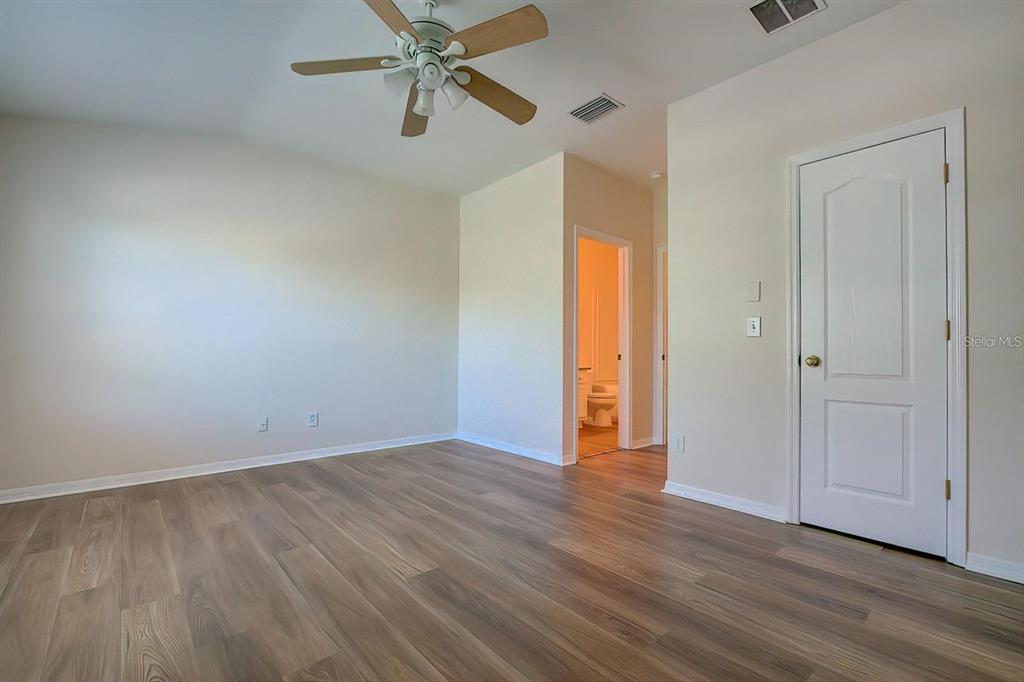 15706 Stable Run Drive Spring Hill, FL 34610 - Photo 28 of 40 an empty room with wooden floor closet and windows