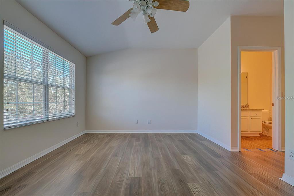 15706 Stable Run Drive Spring Hill, FL 34610 - Photo 29 of 40 wooden floor in an empty room with a window