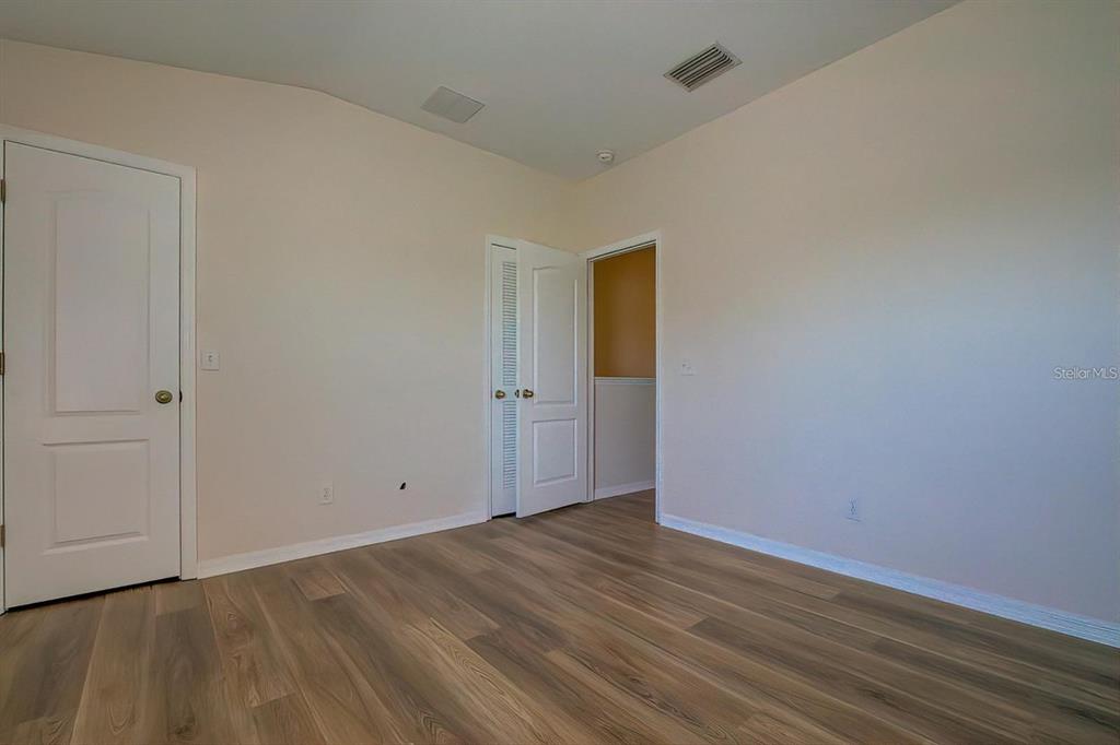 15706 Stable Run Drive Spring Hill, FL 34610 - Photo 32 of 40 a view of an empty room with wooden floor