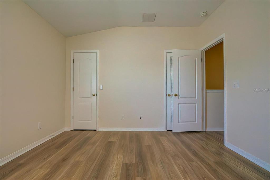15706 Stable Run Drive Spring Hill, FL 34610 - Photo 33 of 40 an empty room with wooden floor