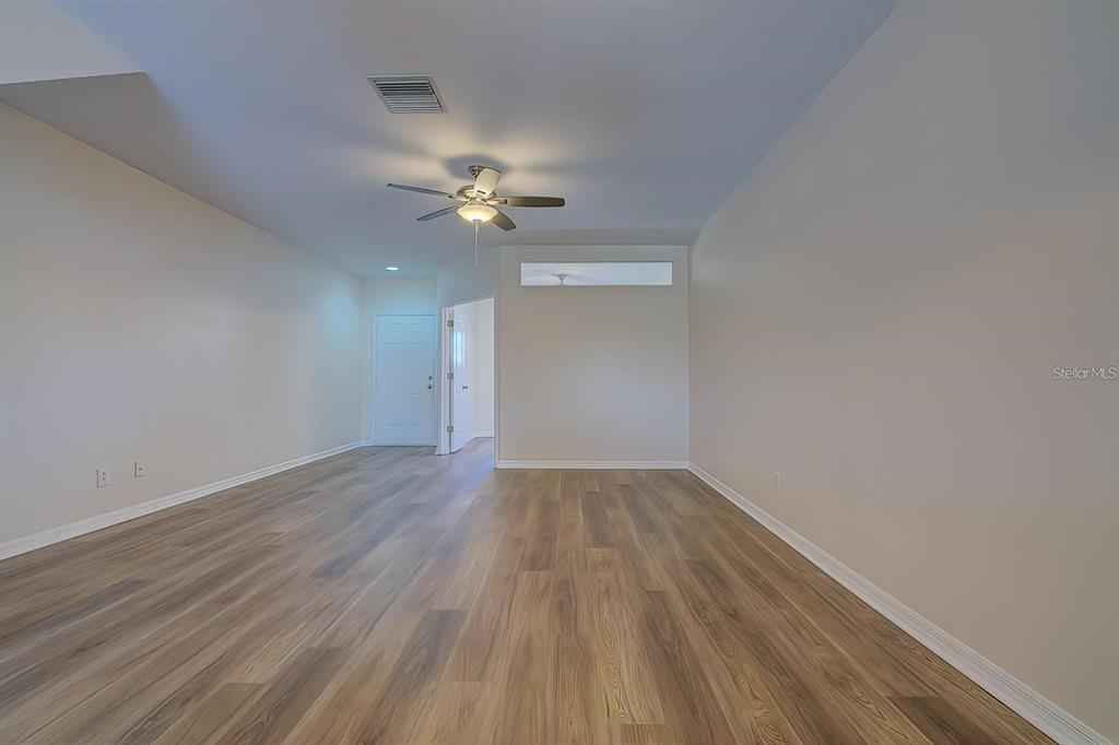 15706 Stable Run Drive Spring Hill, FL 34610 - Photo 7 of 40 wooden floor in an empty room with a window