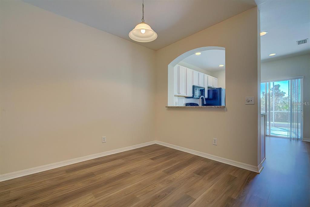 15706 Stable Run Drive Spring Hill, FL 34610 - Photo 9 of 40 an empty room with wooden floor and window